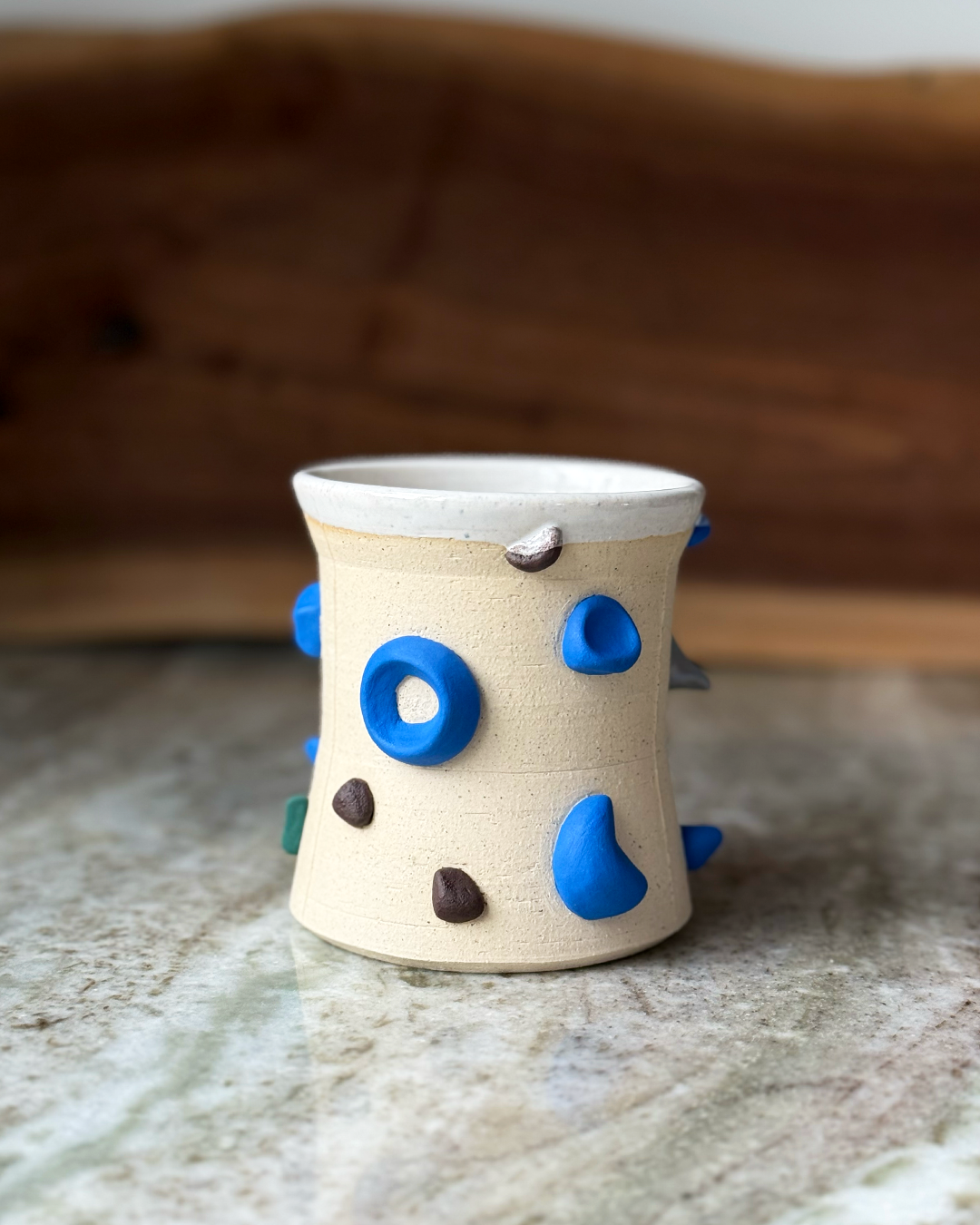 Mug Inspired by a climbing wall white glaze inside a marble and wood backdrop