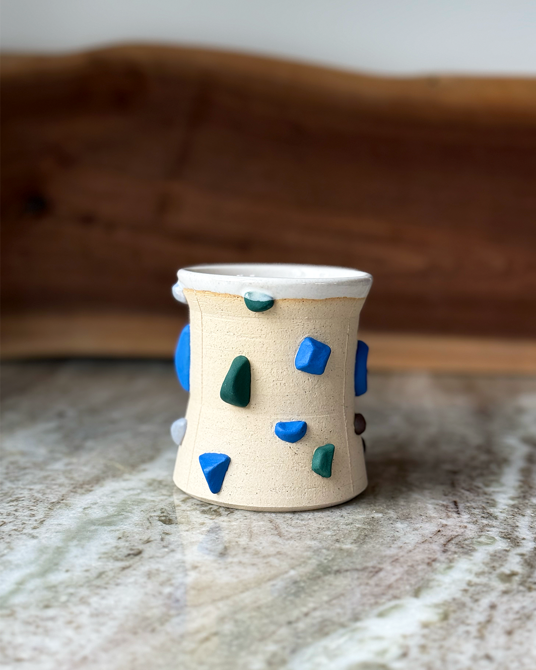 Mug Inspired by a climbing wall white glaze inside a marble and wood backdrop