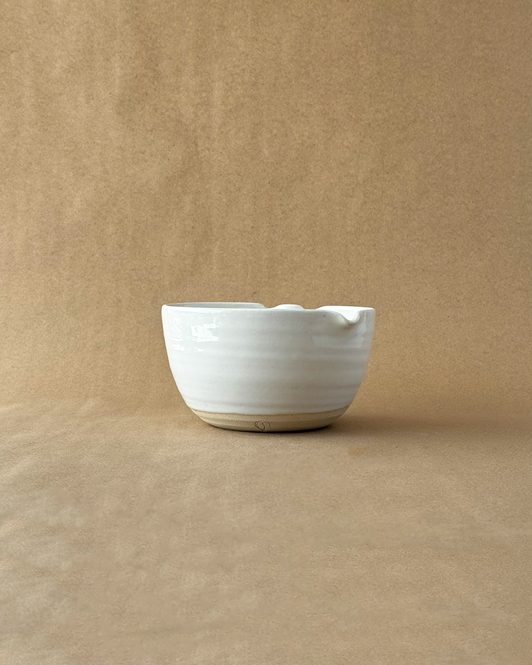 White ceramic bowl on a beige background