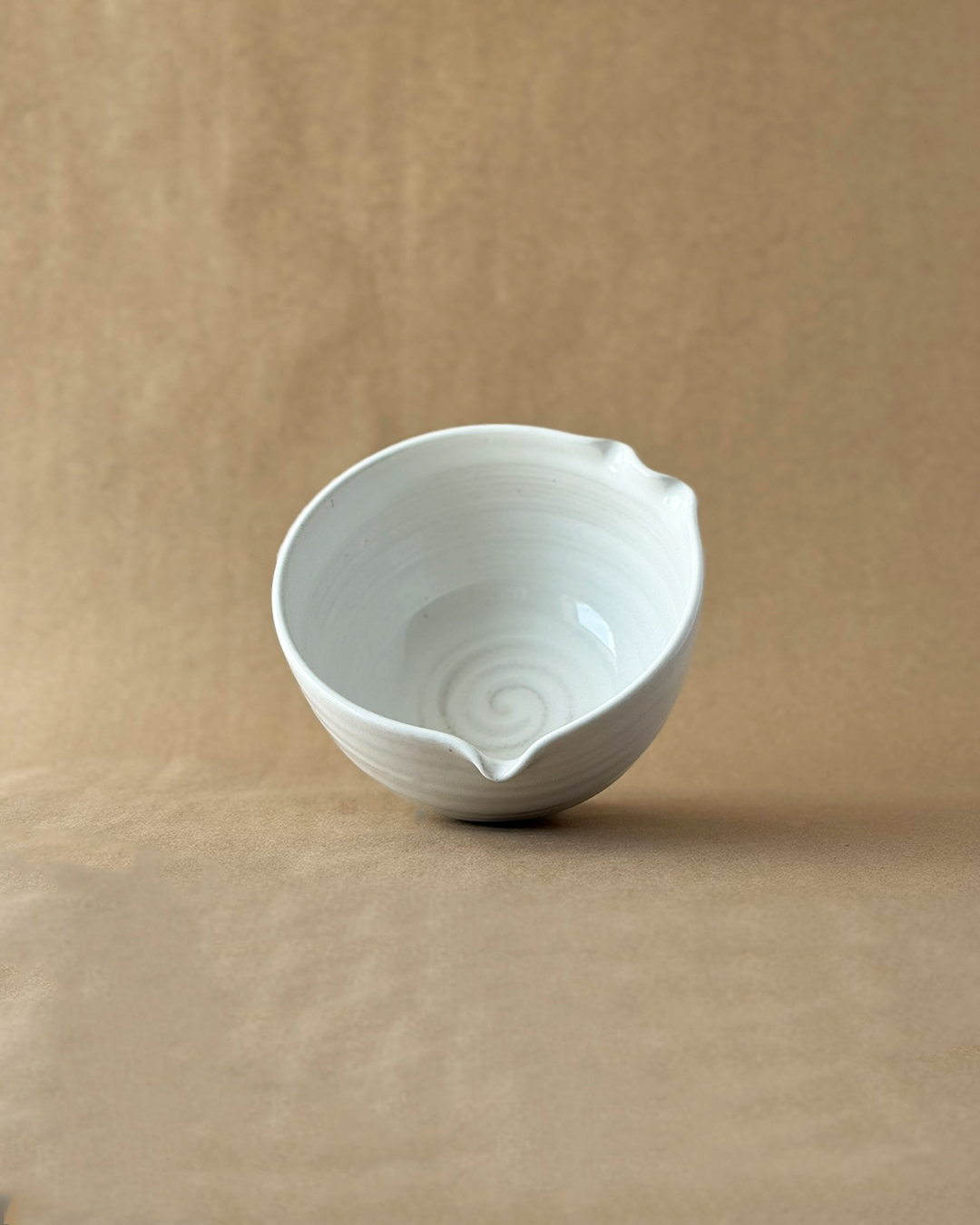 White ceramic bowl on a brown background