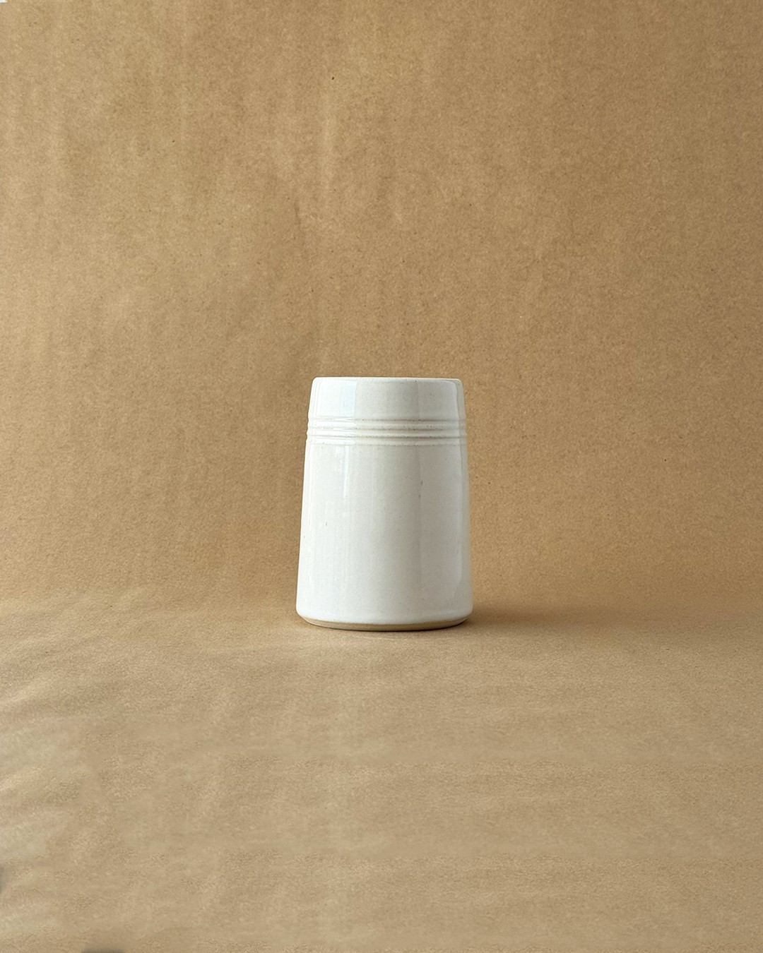 White ceramic mug on a brown background