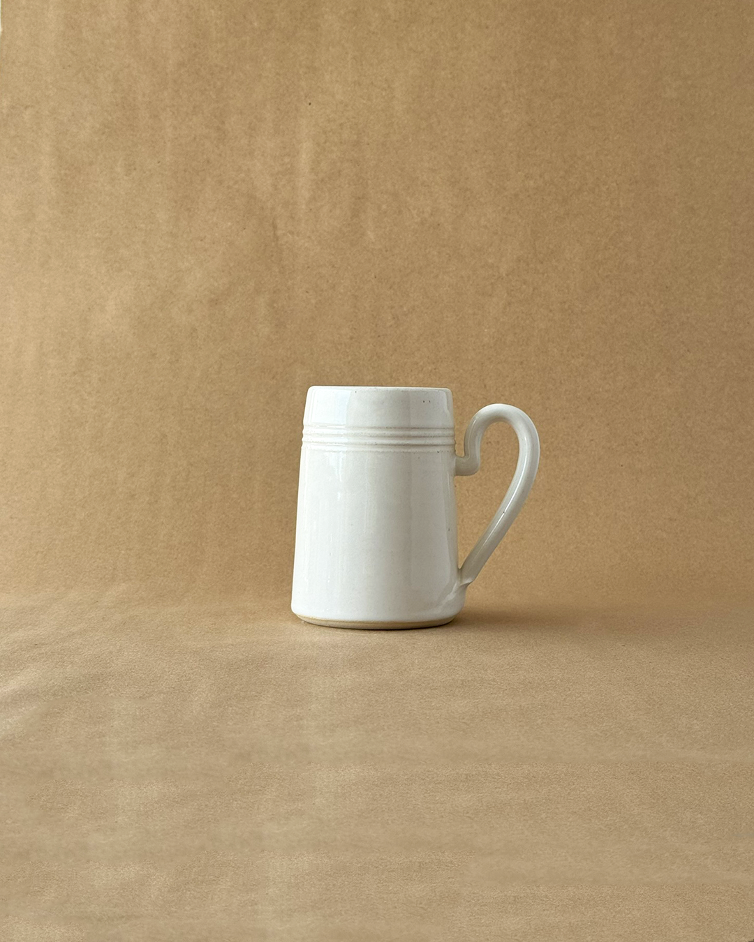 White ceramic mug on a brown background