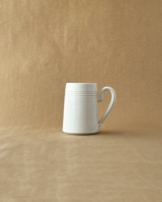 White ceramic mug on a brown background