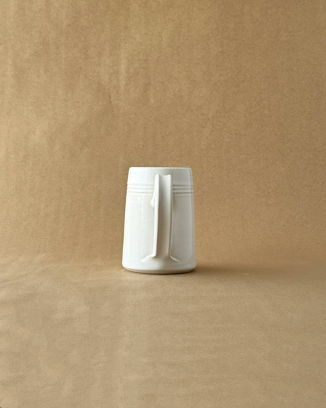 White ceramic mug on a beige background
