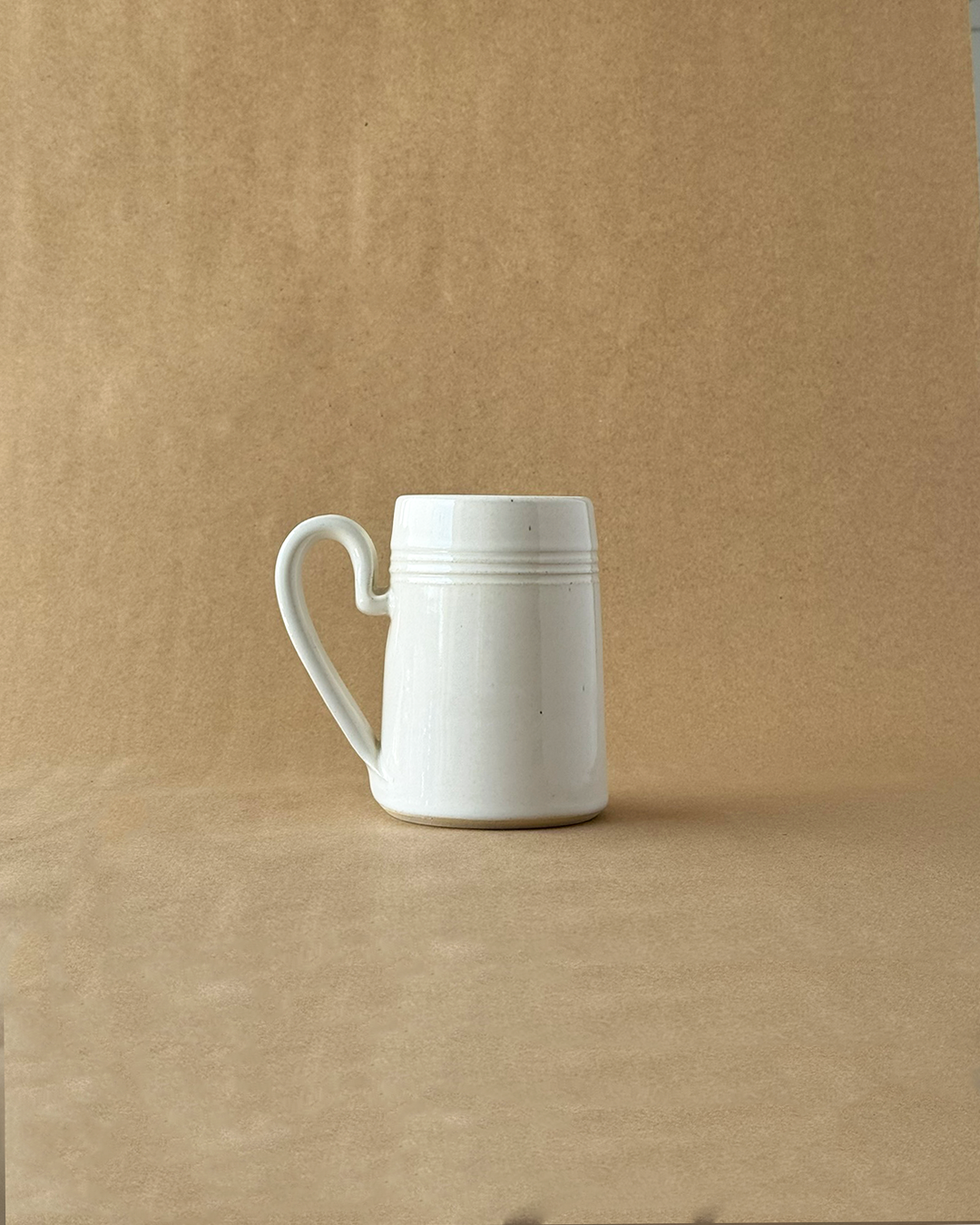 White ceramic mug on a brown background