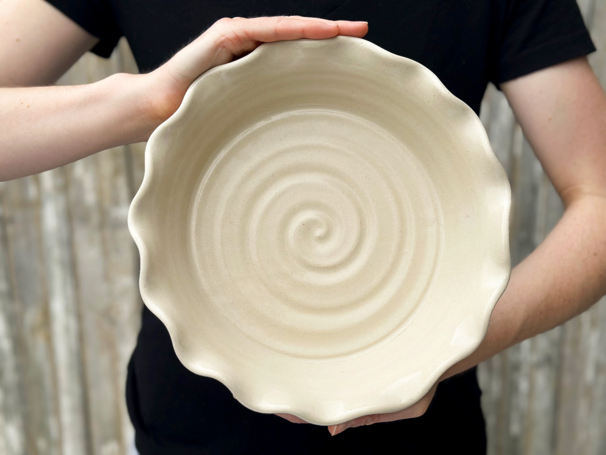 Linen pie dish being held by a person wearing a black shirt